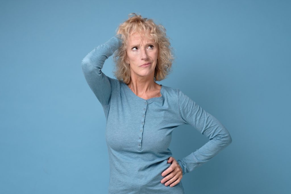 Confused caucasian senior woman thinking making a plan.